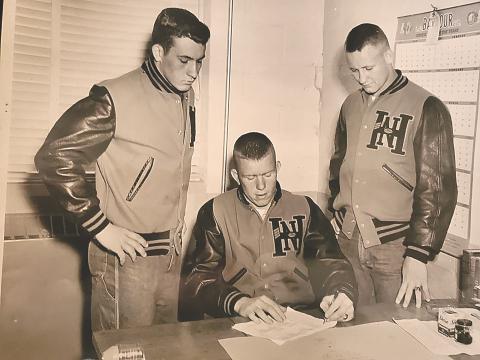 Red Black (center) signs with UGA to play baseball following his senior season at North Habersham High School as teammates Ernest Todd (left) and Howard Burke (right) look on. Black was a three-sport star for the Bobcats and was awarded All-State Honorable Mention honors following the 1954 football season. Photo submitted by Chuck Black.