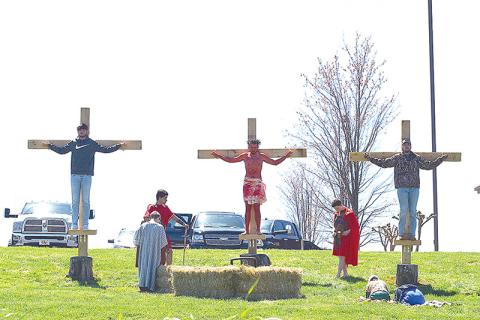 Nick Daunch, one of the participants who played Jesus last Friday, is shown with his brothers, Luke and Noah Daunch, playing the two thieves. Marcus Herrera and Jack Butterworth played the guards.