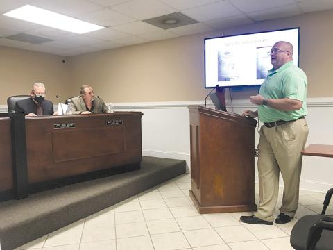 Longtime firefighter Johnny Irvin explains to the Demorest City Council, including Councilmen Jim Welborn and Nathan Davis, his recommendations for a fire truck purchase.