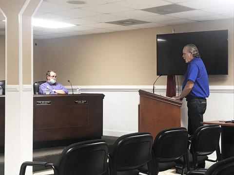 Chuck Miller, vice president for the Marion Body Works fire truck dealer for the state of Georgia, makes a presentation at Tuesday’s Demorest City Council meeting as Councilman Nathan Davis listens.