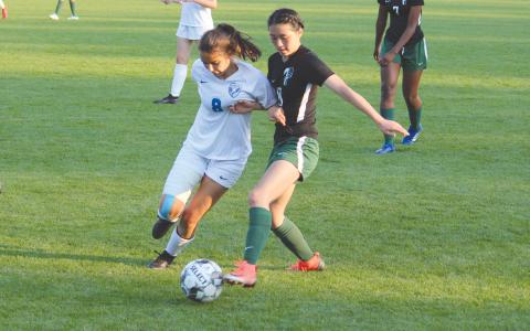 TFS’ Grace Kim (right) battles an AIS defender for the ball during the opening round of the state tournament. ISAIAH SMITH/Staff 