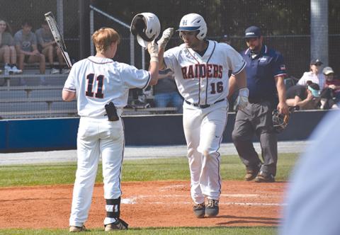 Logan Hare (16) high-fives teammate Austin Jones (11) following a solo home run in the first of two games Wednesday.