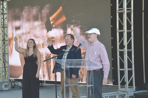 Piedmont University graduate Caitlin Fisher, Vice President for Marketing and Communications John  Roberts and President James Mellichamp toast the new christening of the school as a university Wednesday with sparkling apple juice.