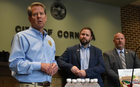 Gov. Brian Kemp (left) talks Thursday at Cornelia City Hall as Mayor John Borrow and City Manager Dee Anderson listen. CHAMIAN CRUZ/Staff 