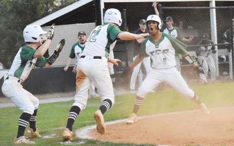 Baylor Carnes, Chathan Clouatre and Malique Charlton celebrate after scoring a couple of late runs in last Tuesday’s game against Athens Christian Academy. CODY ROGERS/Staff