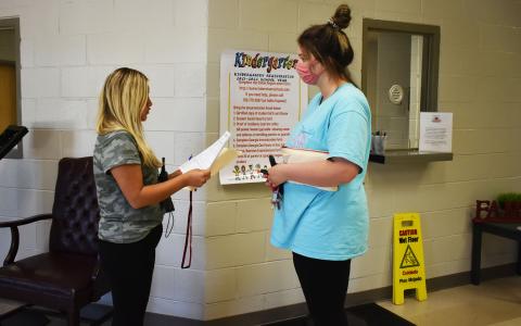 Karla Paramo, left, is the only Parent Involvement Coordinator at Level Grove Elementary School right now. On Tuesday, she met with parent Kayla Gerrells to go over some documents she needed to sign. CHAMIAN CRUZ/Staff