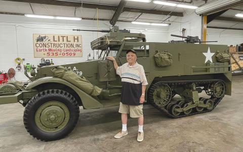 Andy Negra took a look at a halftrack military vehicle at Joe Hatfield’s workshop in  Clarkesville on Thursday. Negra drove a  similar vehicle in World War II. BRIAN WELLMEIER/Staff
