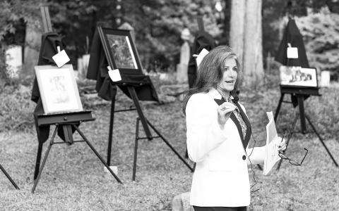 Volunteer auctioneer Leigh Johnston leads the bidding at the Gloaming Picnic & Art Auction, held Saturday. E. LANE GRESHAM/Submitted 