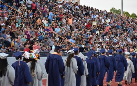 Habersham Central’s graduates walk past the home stands, which were full of well wishers Friday after a socially-distanced ceremony last summer. MATTHEW OSBORNE/Staff 