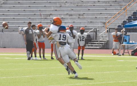 Cole Gragg (19) lays a hit on a receiver in the middle of the field during Wednesday’s practice. ISAIAH SMITH/Staff