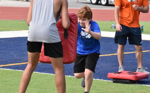 Henry Burgess makes a block during camp Tuesday. ISAIAH SMITH/Staff