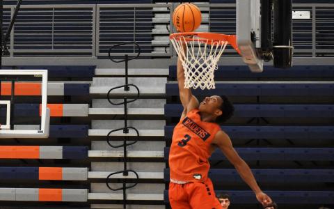 Malachi Dooley elevates and looks to finish an alley-oop during a drill Monday night. ISAIAH SMITH/Staff