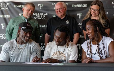 Tallulah Falls’ Simeon Respress signed a track scholarship with Anderson University on Tuesday. Respress was joined by (front row, from left) stepfather Chaun Young, mother Veronica Young, along with (back row, from left) TFS head track coach Scott Neal, TFS President Larry A. Peevy and TFS Upper School Academic Dean Kim Popham. BRIAN CARTER/Submitted