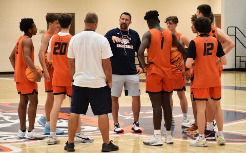 Aric Mawdesley speaks with the Raiders varsity players during his first practice with the team Monday night. Mawdesley joins the Raiders after successful head coaching stints at Berrien County and North Cobb Christian. ISAIAH SMITH/Staff 