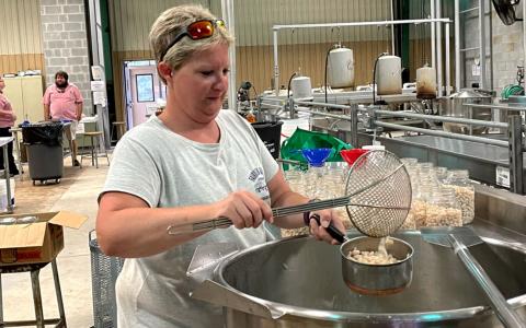 Christy Petitt works on canning Great Northern beans at the Habersham Canning Plant. BRIAN WELLMEIER/Staff 