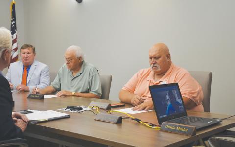 County Commissioners Bruce Harkness, Jimmy Tench and Bruce Palmer hold called meeting before executive session. BRIAN WELLMEIER/Staff