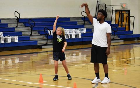 Shamir Dooley goes through a workout with Teagen Hicks. Dooley conducts individual workouts most days each week, along with coaching a travel team in his down time. ISAIAH SMITH/Staff 