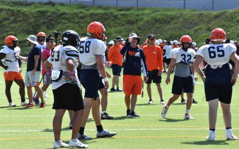 Raiders’ head coach Benji Harrison signals in the play call to his offense between plays at Habersham Central football camp Wednesday. ISAIAH SMITH/Staff 