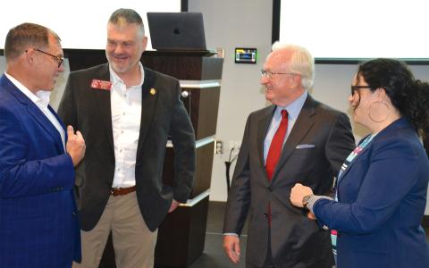 Outgoing County Manager Phil Sutton (second from right) talks with former county commissioners (from left) Stacy Hall, Victor Anderson and Natalie Crawford at Wednesday’s Partnership Habersham meeting, where Sutton was honored by local leaders. MATTHEW OSBORNE/Staff
