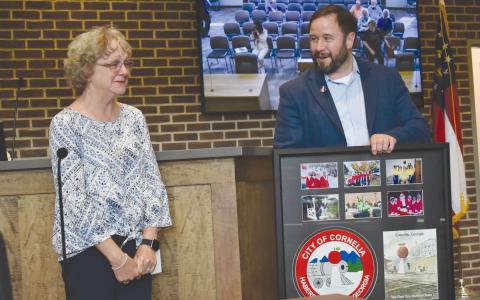 Cornelia Mayor John Borrow presented City Clerk Janie Henderson with a special gift which included a key to the city at Tuesday night’s meeting to honor her 24 years of service to the city. CHAMIAN CRUZ/Staff 