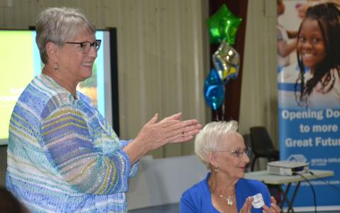 Annette Lee (left) and Sandra Deal applaud a speaker during the open house event Thursday evening for the Habersham County Boys & Girls Club. BRIAN WELLMEIER/Staff 