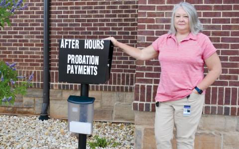 Cornelia Probation Officer Stephanie Smith stands beside the probation fee dropbox outside the Cornelia Municipal Complex. CHAMIAN CRUZ/Staff
