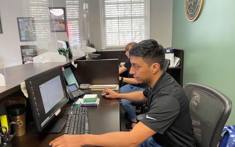 Gabriel Gutierrez works to pull student data at the Piedmont University admission office. BRIAN WELLMEIER/Staff