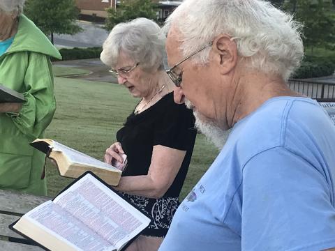 Sue Carnes and Dave Pelphrey read passages from the Book of Luke at Wednesday morning’s statewide reading event at the Habersham County Courthouse. MATTHEW OSBORNE/Staff 