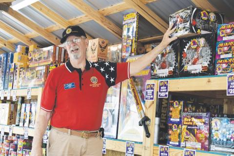 Edwin Hendricks, post commander of the American Legion Post 84, works the Phantom Fireworks stand in Cornelia to try to raise money for his organization on Thursday. CHAMIAN CRUZ/Staff