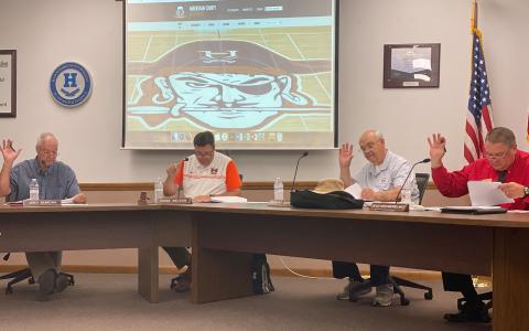 School board member Joey Duncan, chairperson Russ Nelson, board member Robert Barron and vice chairperson Doug Westmoreland vote on the rollback millage rate Monday. Not pictured is board member Kristie Dover. CHAMIAN CRUZ/Staff