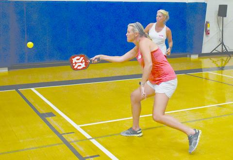 Alyson Paul (front) and Myrna Owen-Olsson compete in the Round Robin pickleball fundraiser at Ruby Fulbright Aquatics Center.