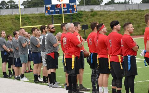 First responders participating in Saturday night’s Battle of the Heroes stand at attention before the beginning of the game. BRYANT ROCHE/Staff 