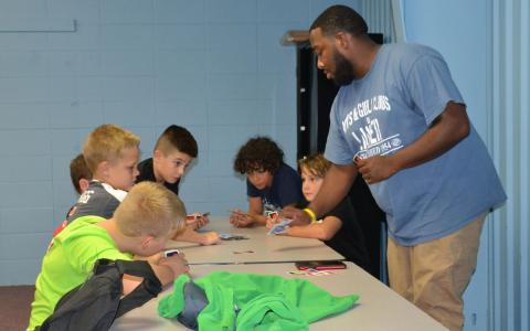 Qymane Brawner works with students at the Tim Lee Boys and Girls Club. BRIAN WELLMEIER/Staff 