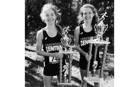 Audrey and Abigail Hotard show off their trophies from last year’s Middle School State Cross Country Championships. Abigail finished first and Audrey finished second in the championship race for all schools competing in the GHSA 5A, 6A and 7A classifications.