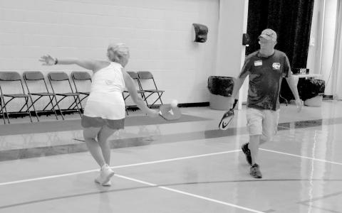 Myrna Owen flips a backhand to help partner Phil Vorhees. BRYANT ROCHE/Staff