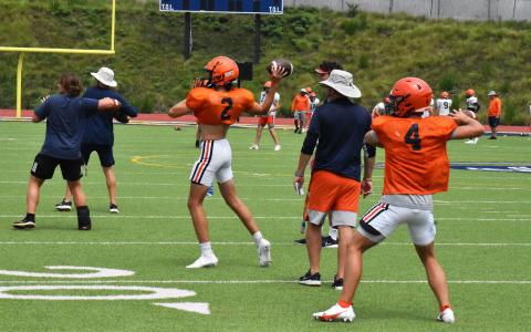 Habersham Central coach Benji Harrison oversees quarterbacks Cooper Smith (2) and Carson Parker (4) during practice Monday afternoon. MATTHEW OSBORNE/Staff