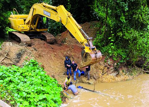 Demorest public works employees tend to a damaged pipe earlier this summer. Excessive rains have kept workers busy. BRYAN POPHAM/Submitted