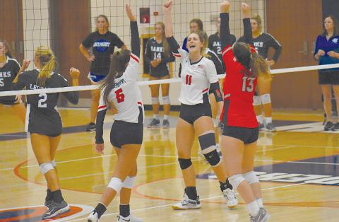 Habersham Central’s MaryKate Bush, Allie Church and Ansley McAllister celebrate a point during a home game against Banks County. CODY ROGERS/Staff