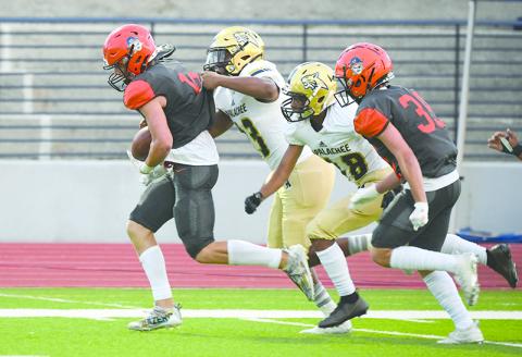 Habersham Central’s Noah Wilson breaks away from Apalachee tacklers after making a catch last Friday night. TOM ASKEW/Special