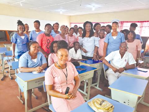 Dr. Marcella Davies (middle back with bracelet) stands with her students in Sierra Leone.