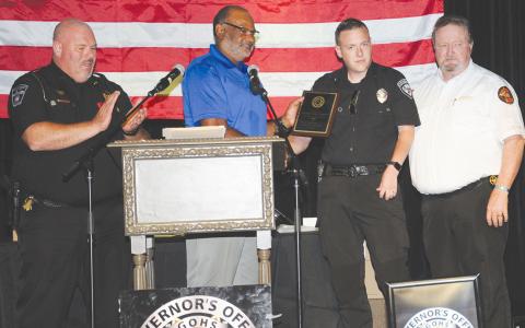 Demorest Police Chief Robin Krockum applauds as Allen Poole, director of the Governor’s Office of Highway Safety, presents an award for DUI patrol officer of the year to Alto’s John Groves in McCaysville on Sept. 9. Franklin County Sheriff Steve Thomas also was on hand for the presentation. GLENN HARBISON/CNI News Service
