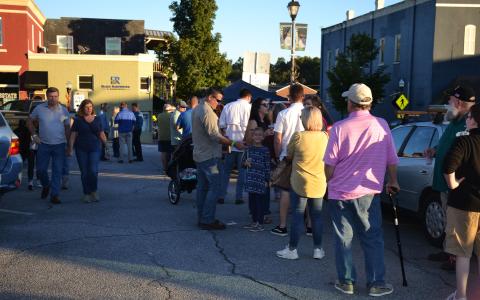 Members of the community line up for drinks in downtown Clarkesville on Friday night. BRIAN WELLMEIER/Staff