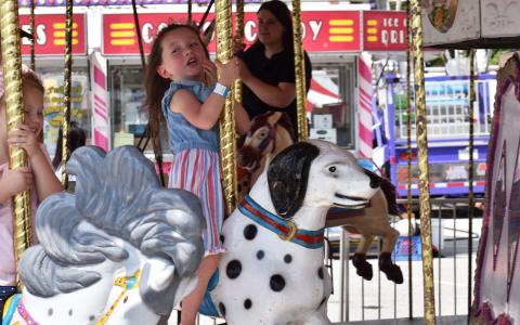 Hallie Hatchett and Oaklynn Edge enjoy the merry-go-round on Saturday afternoon at the Chattahoochee Mountain Fair. MATTHEW OSBORNE/Staff