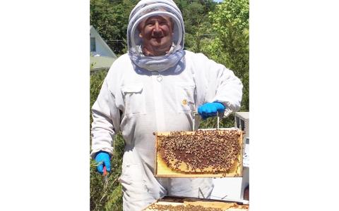 Habersham County Commissioner Bruce Harkness tends to his beehives on his property in Demorest. Harkness’ family has kept bees for the last 200-plus years. BRUCE HARKNESS/Submitted