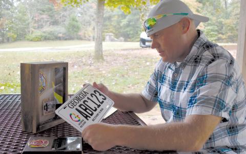 Jeremy Mitchell reflects on his time spent as a firefighter before running afoul of drugs and getting off track. The license plate was given for successful completion of drug court. MATTHEW OSBORNE/Staff