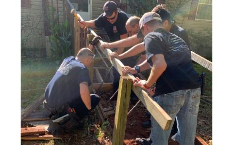 Jim Wood, Brandon Fields, Randi Seabolt, Kadyn Harper, Brendan Hall and Alfredo Vegapaniagua work to repair a ramp at the home of a local senior couple. CHAD BLACK/Submitted