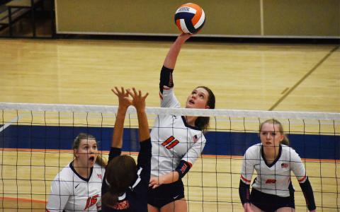 Allie Church soars above the net and lofts the ball back over the defending team for a point during one of last Thursday’s wins. CODY ROGERS/Staff