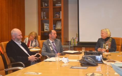 Habersham Medical Center CEO Tyler Williams (middle) talks with Hospital Authority members Dr. Joshua Garrett (left) and Chair Dolly Ritchie (right) during Tuesday’s meeting. BRIAN WELLMEIER/Staff