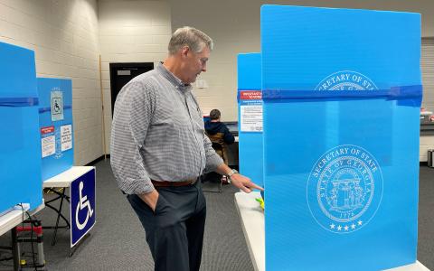 Pastor Mike Franklin of The Torch casts his ballot Thursday at the Ruby Fulbright Aquatic Center. BRIAN WELLMEIER/Staff