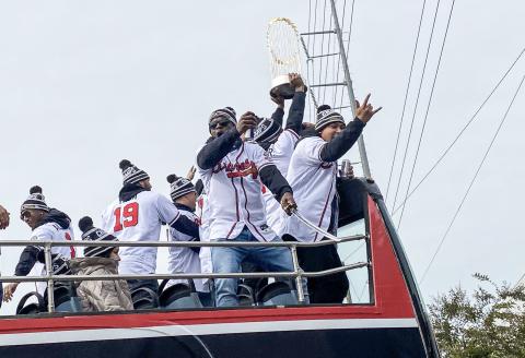 With a beer in one hand and a samurai sword in the other, Guillermo Heredia celebrates with his teammates during the Braves’ World Series Champion Parade on Friday, Nov. 5. Also pictured are players Ozzie Albies, Huascar Ynoa, William Contreras, Roñald Acuna Jr. and Orlando Arcia. CODY ROGERS/Staff